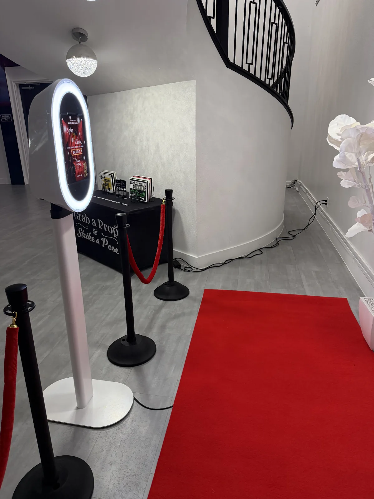 Snapshot Solutions stationary photo booth with red carpet and velvet ropes